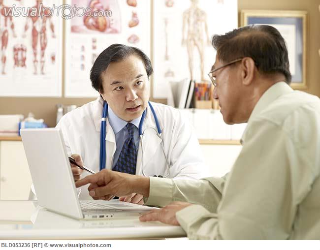 Asian male doctor talking to patient